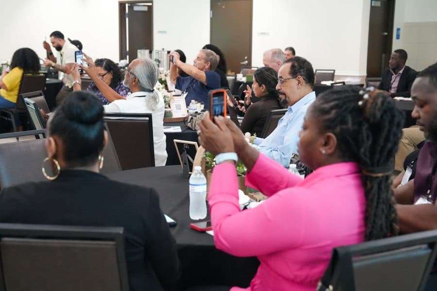 Business owners photographing a slide during the talk