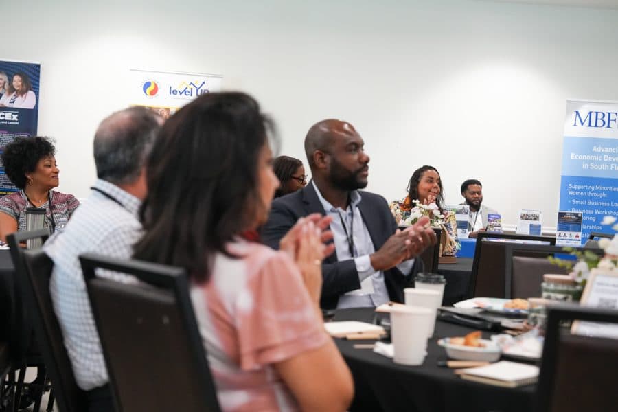 Attendees applauding at the Summit